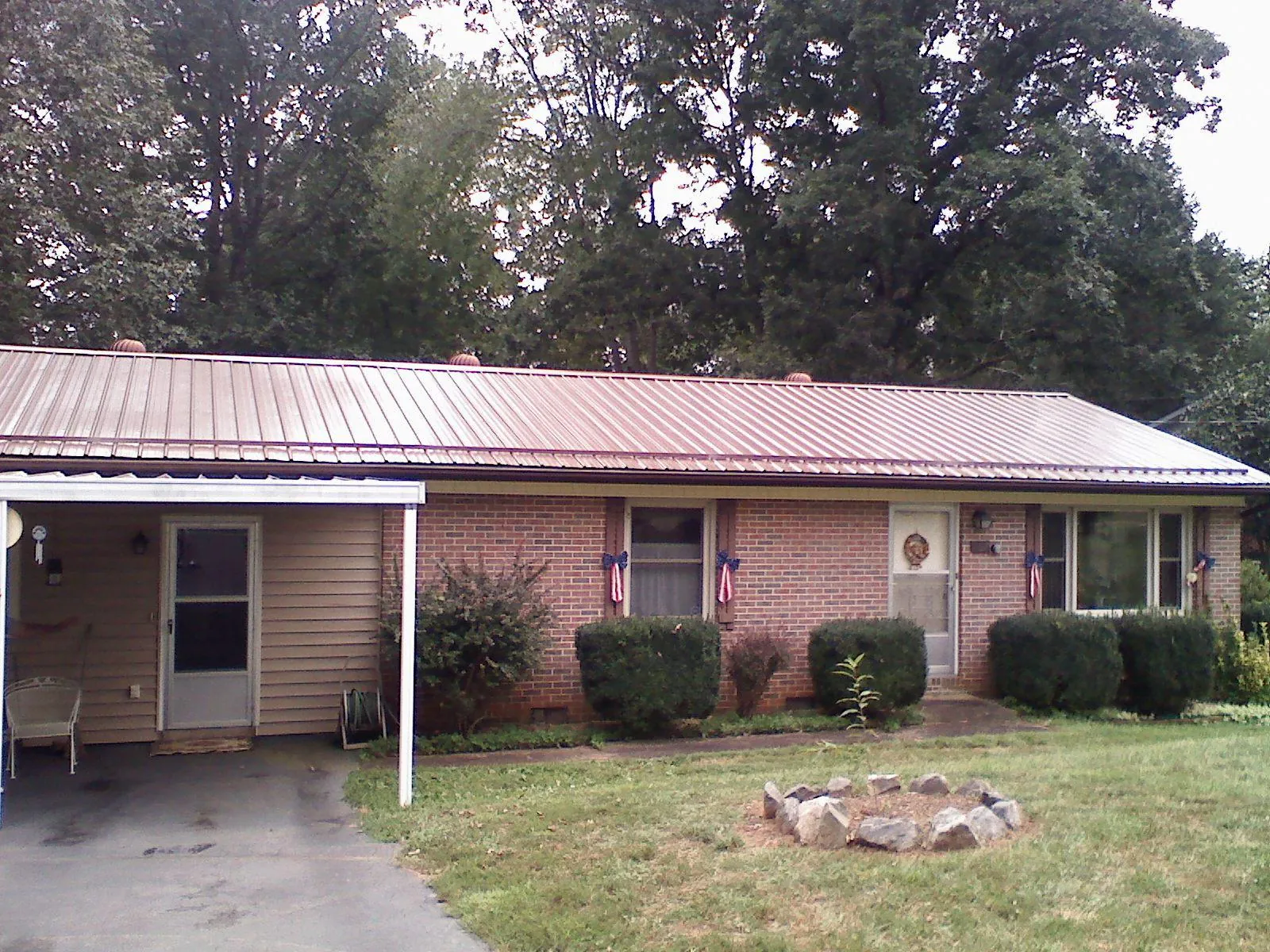 Bronze metal roof and carport on a brick ranch home — Roof Repair work by our crew in Coffeen